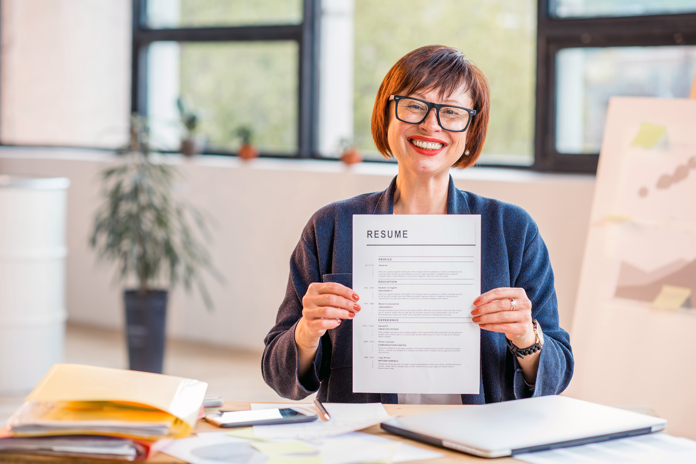 woman holding resume up
